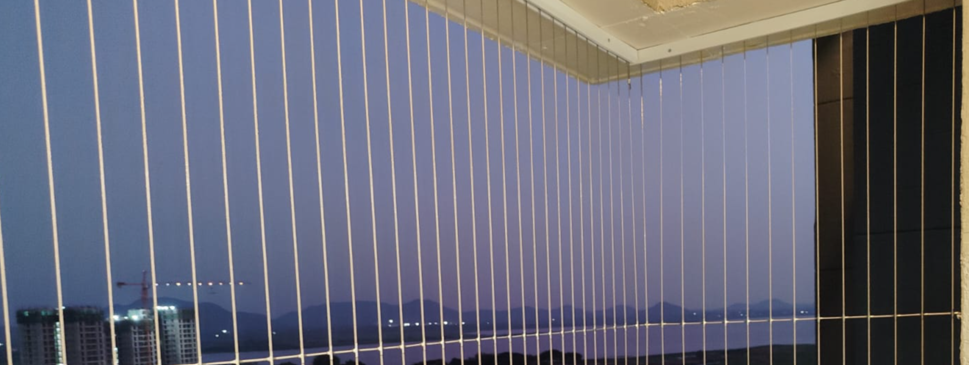 Rust-resistant invisible grills installed on a balcony with an unobstructed outdoor view.