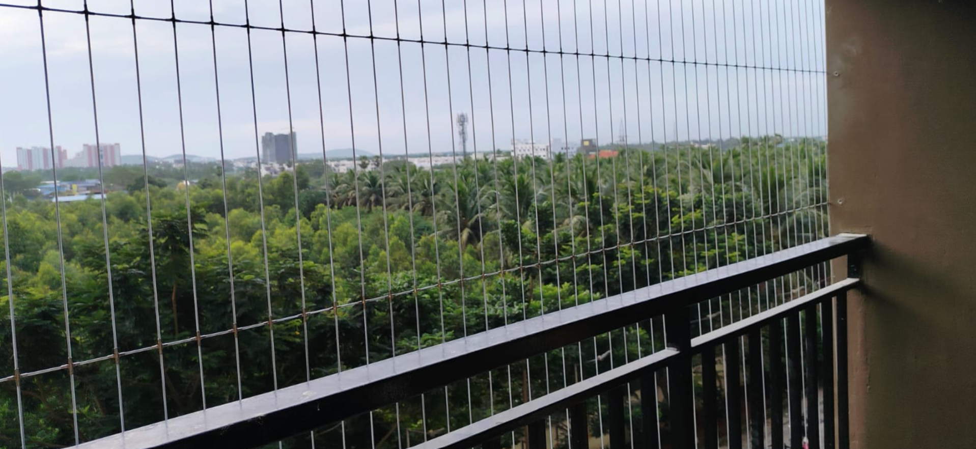 Modern invisible grill system offering safety, ventilation, and a clear balcony view.
